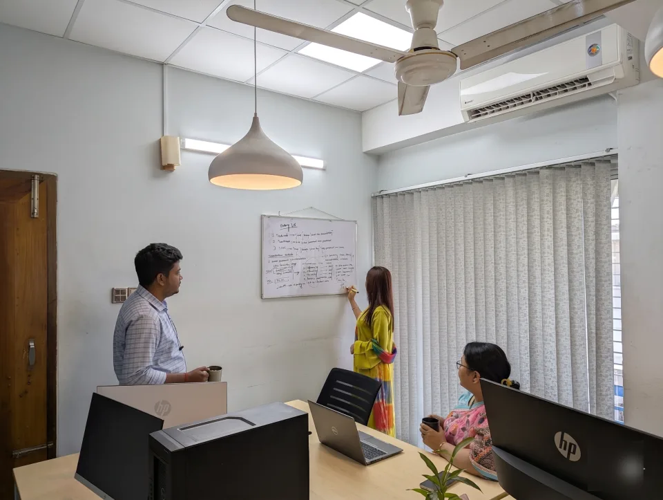 ReformedTech team mapping out a problem on the whiteboard